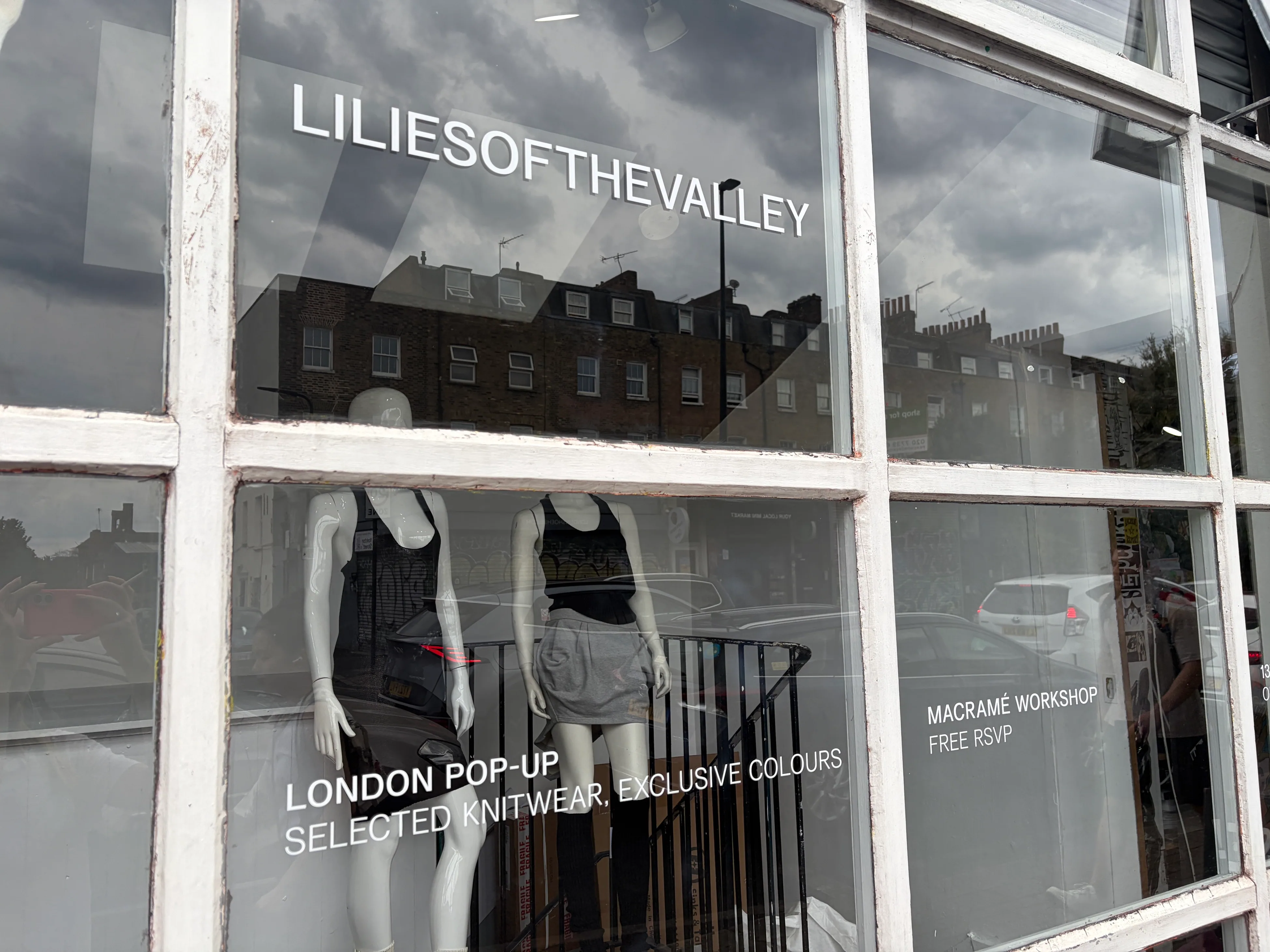 Detail of the window vinyl: London pop-up, selected knitwear, exclusive
                    colours, and the free macramé workshop RSVP.